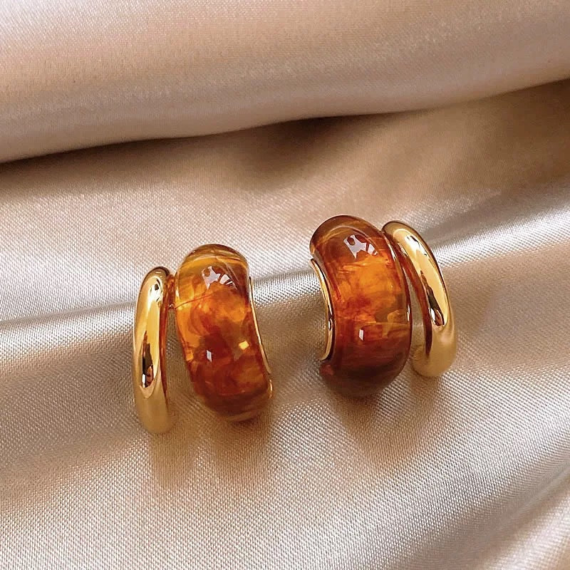Brown amber C-hoop earrings with polished gold-tone setting
