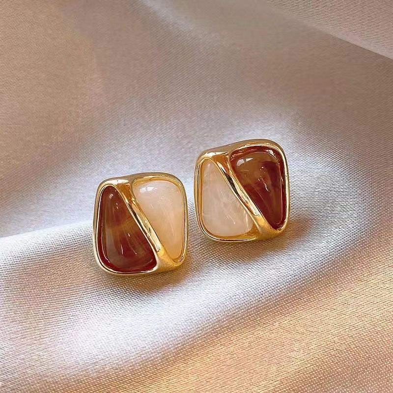 Two-tone amber and caramel geometric stud earrings with gold-tone frame