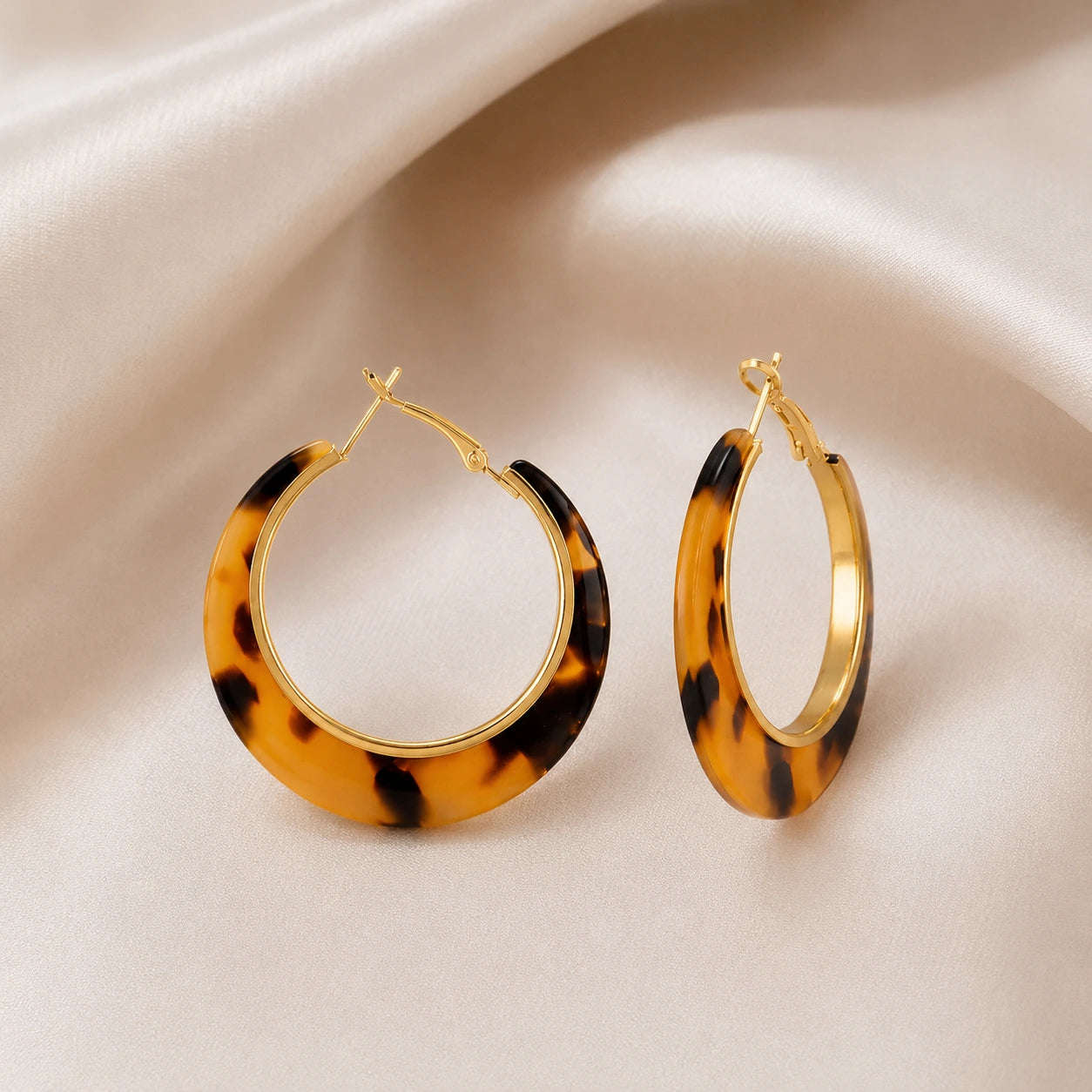 Tortoiseshell amber hoop earrings with brown black and gold-tone details