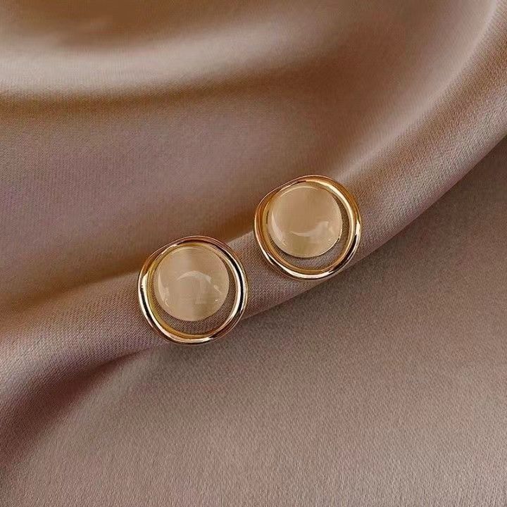Honey opal round stud earrings with polished gold-tone halo frame