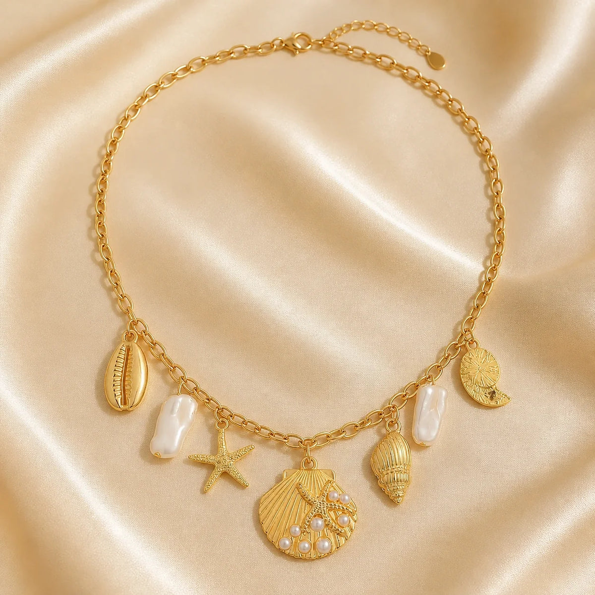 Ocean Charm Shell & Starfish Necklace displayed on champagne satin